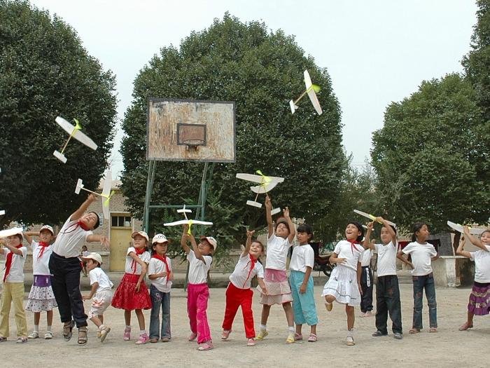 Kids playing paper air plane